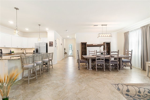 dining space featuring crown molding, recessed lighting, plenty of natural light, and baseboards