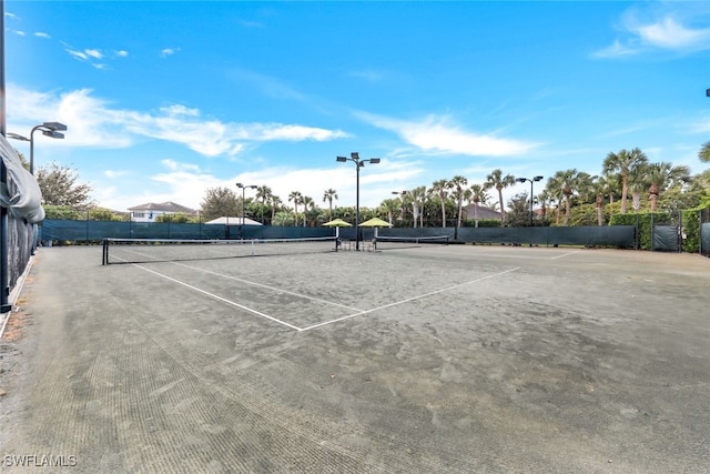 view of tennis court with fence