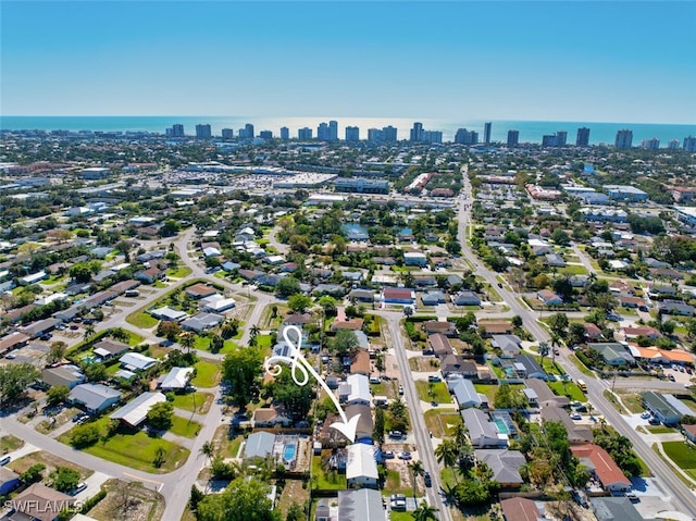 birds eye view of property featuring a view of city and a water view