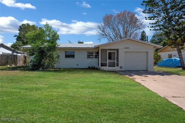 ranch-style house featuring metal roof, a garage, fence, driveway, and a front lawn