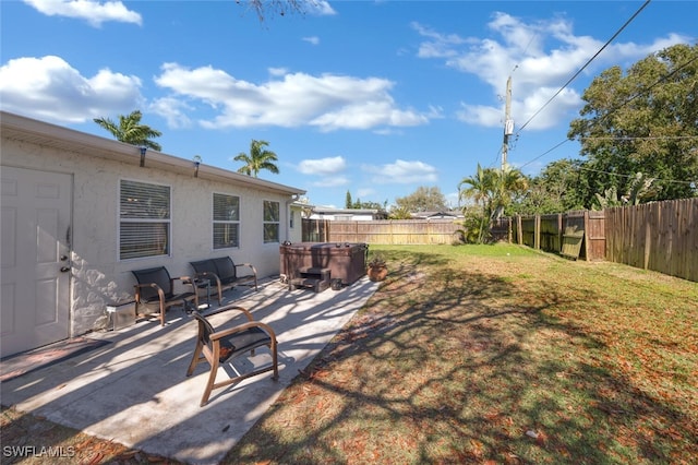 view of yard featuring a patio area, a hot tub, and a fenced backyard