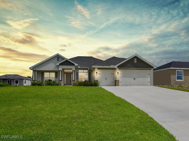 craftsman-style house with a lawn and a garage