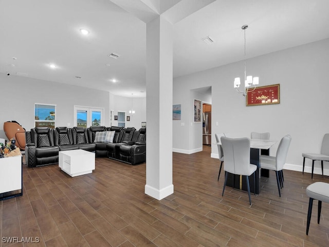 dining area featuring dark hardwood / wood-style floors and a notable chandelier