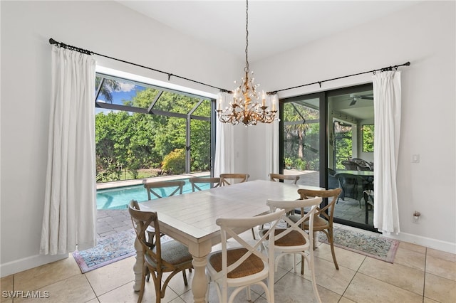 tiled dining room featuring a healthy amount of sunlight and a notable chandelier