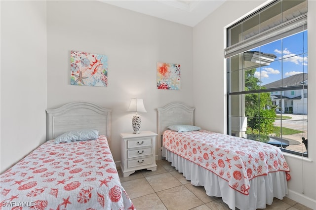 bedroom featuring light tile patterned floors and multiple windows