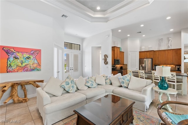 living room featuring a high ceiling, light tile patterned floors, and crown molding