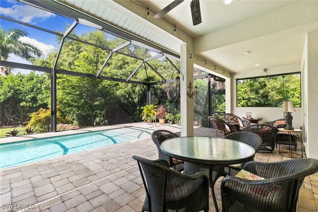 view of swimming pool with glass enclosure and a patio area