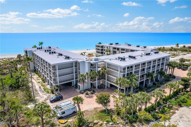 drone / aerial view with a water view and a view of the beach