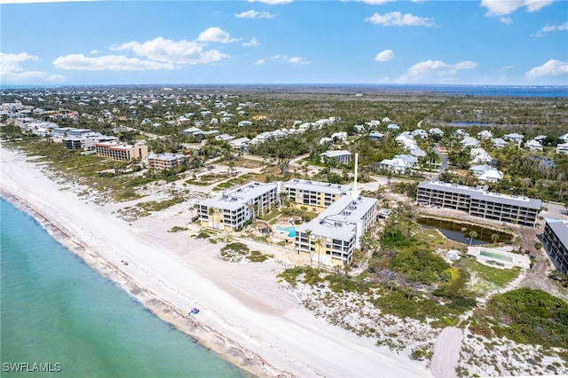 drone / aerial view with a water view and a view of the beach