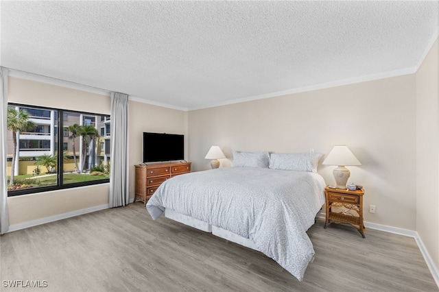 bedroom featuring a textured ceiling and hardwood / wood-style flooring