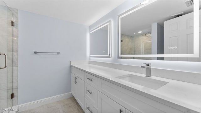 bathroom with vanity, tile patterned floors, and walk in shower