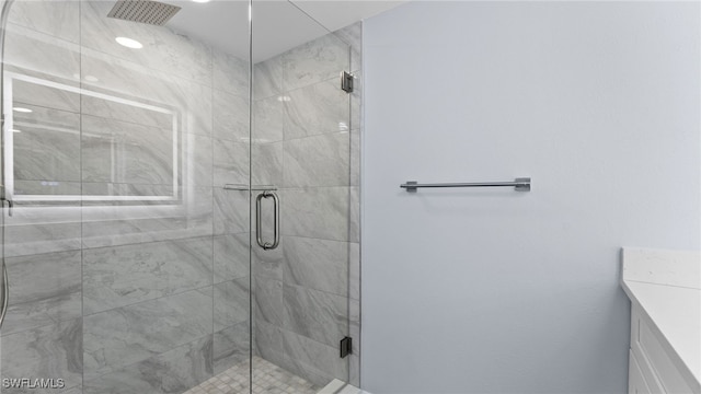 bathroom featuring vanity and a shower with door