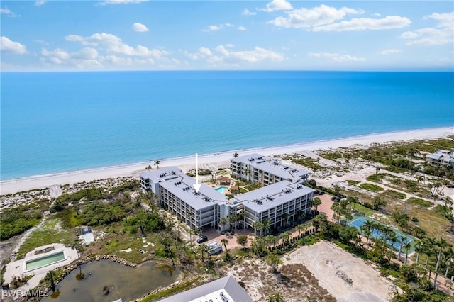 drone / aerial view featuring a water view and a view of the beach