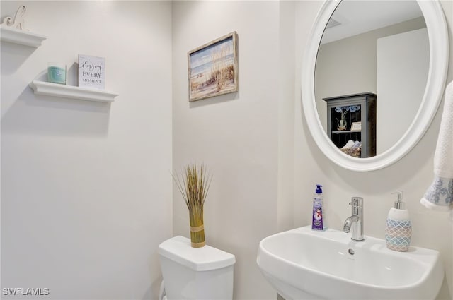 bathroom with sink and toilet