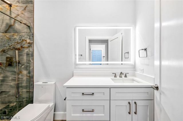 bathroom with vanity, toilet, and a shower