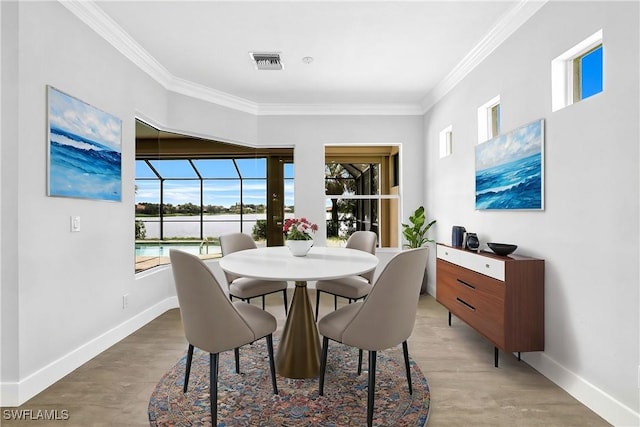 dining area with hardwood / wood-style flooring and ornamental molding