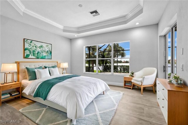 bedroom with crown molding and a tray ceiling