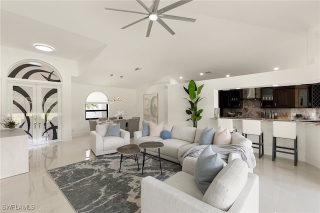 living room featuring ceiling fan with notable chandelier