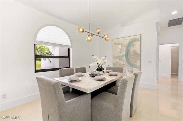 dining room featuring lofted ceiling and light tile patterned floors