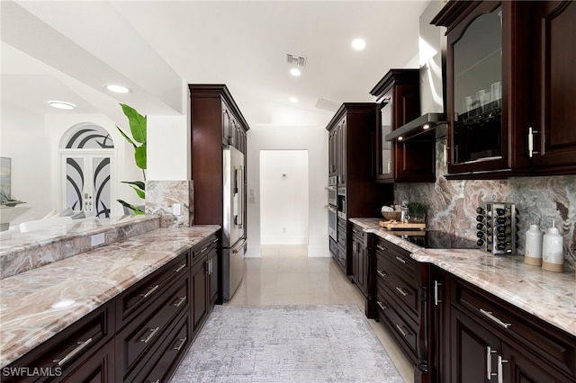 kitchen with lofted ceiling, high quality fridge, dark brown cabinets, backsplash, and black electric cooktop