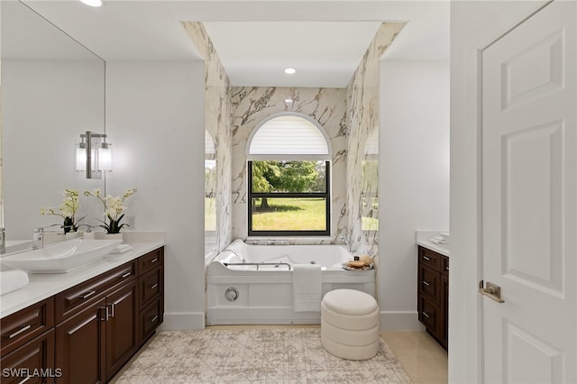 bathroom with vanity, tile patterned floors, and a bathtub