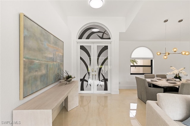 foyer entrance with a chandelier