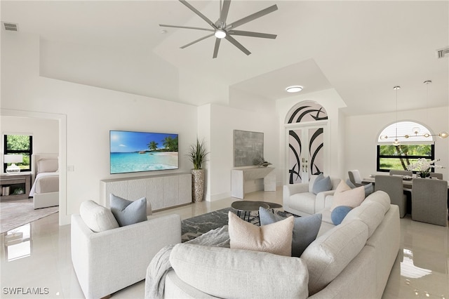 living room featuring vaulted ceiling, ceiling fan, and light tile patterned flooring