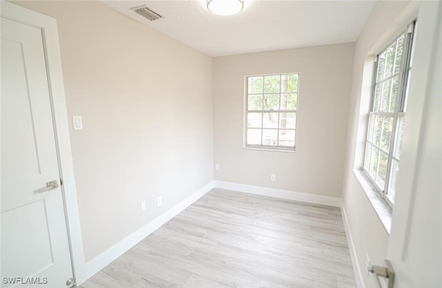 spare room with light hardwood / wood-style flooring