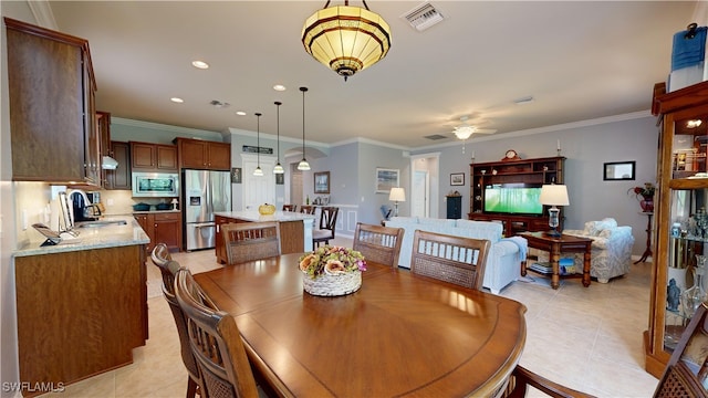 dining room featuring light tile patterned floors, visible vents, and ornamental molding