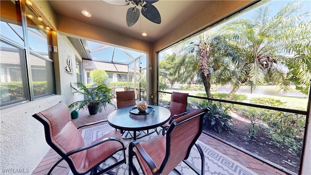 sunroom featuring ceiling fan