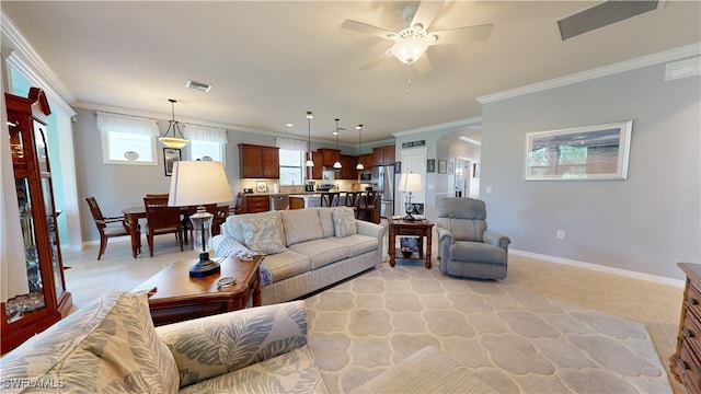 living room featuring visible vents, baseboards, and ornamental molding