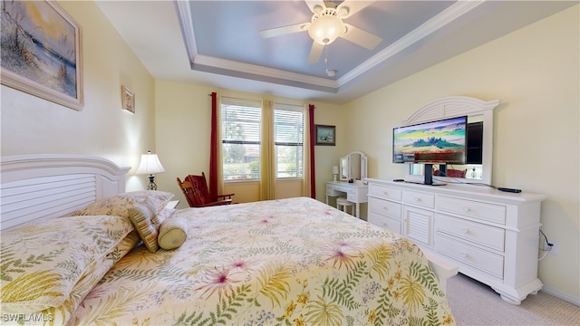 bedroom with light carpet, a raised ceiling, ornamental molding, baseboards, and ceiling fan