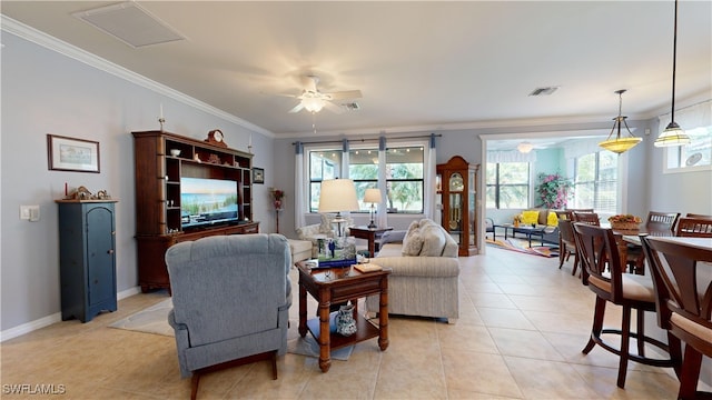 living room featuring light tile patterned floors, visible vents, ceiling fan, and crown molding