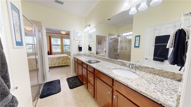 full bathroom featuring visible vents, a sink, a shower stall, tile patterned floors, and connected bathroom