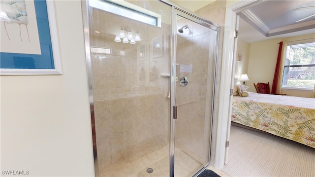 full bathroom featuring a shower stall, crown molding, a tray ceiling, and connected bathroom