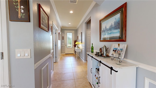 doorway to outside with light tile patterned floors, visible vents, recessed lighting, and crown molding