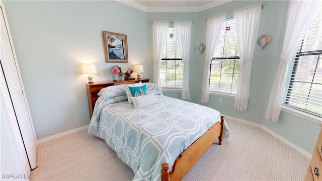 bedroom featuring baseboards, light colored carpet, and ornamental molding