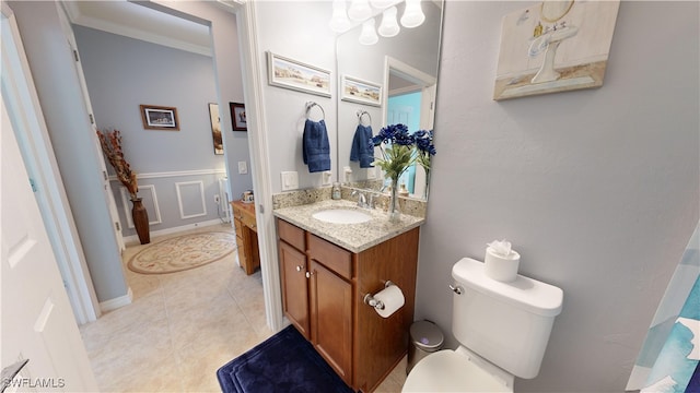 bathroom featuring crown molding, baseboards, toilet, tile patterned floors, and vanity