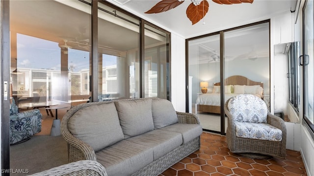 sunroom featuring ceiling fan