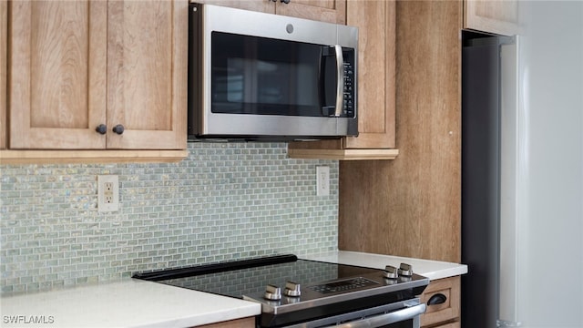 kitchen featuring appliances with stainless steel finishes and backsplash