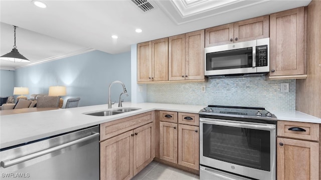 kitchen with light tile patterned flooring, sink, pendant lighting, crown molding, and stainless steel appliances