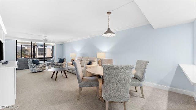 carpeted dining area with ornamental molding