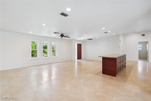 spare room with ceiling fan and light tile patterned flooring