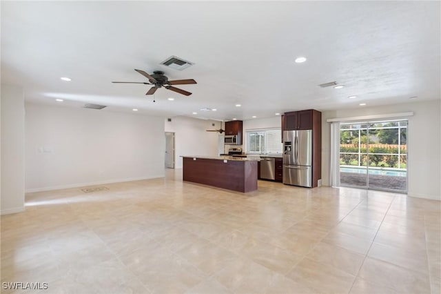 kitchen featuring open floor plan, a kitchen island, visible vents, and stainless steel appliances