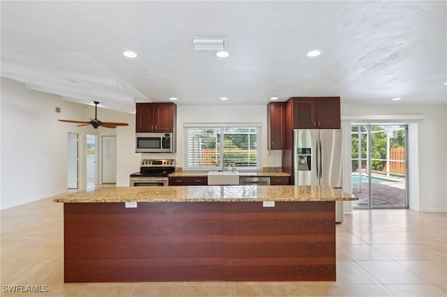 kitchen featuring visible vents, light stone counters, a kitchen island, recessed lighting, and stainless steel appliances