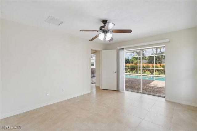 tiled empty room with ceiling fan