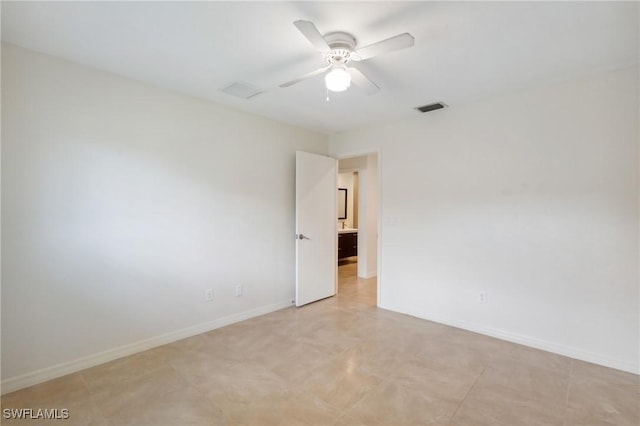 empty room with a ceiling fan, visible vents, and baseboards