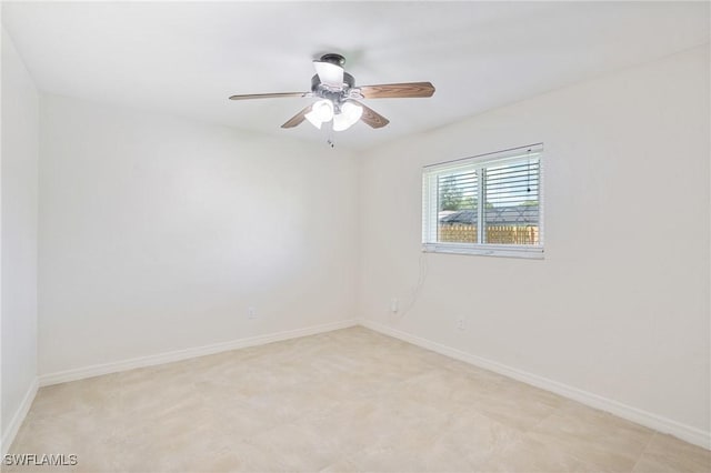 empty room featuring baseboards and ceiling fan