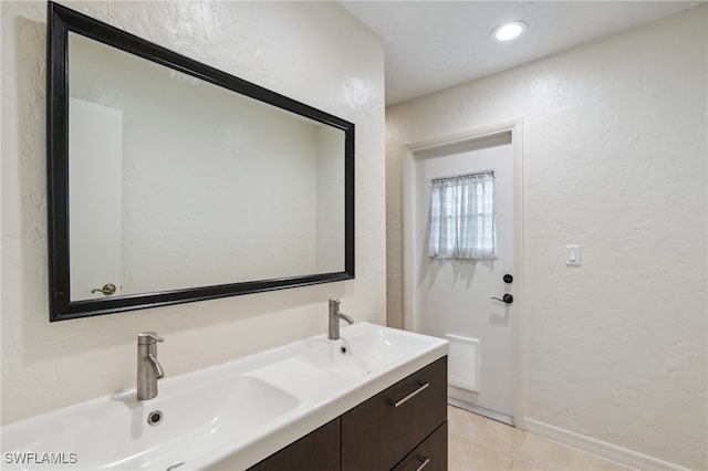 bathroom with tile patterned floors and vanity