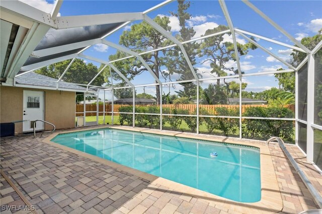 view of pool with a lanai and a patio area